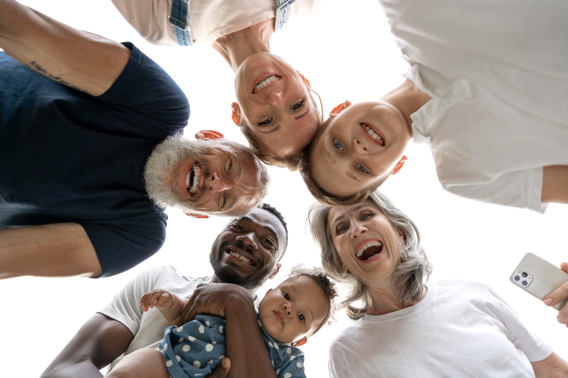 Family gathered together, smiling down at the camera